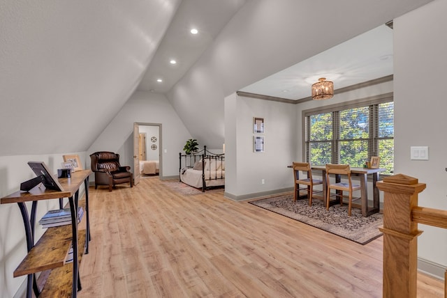 interior space featuring lofted ceiling, baseboards, a notable chandelier, and light wood finished floors