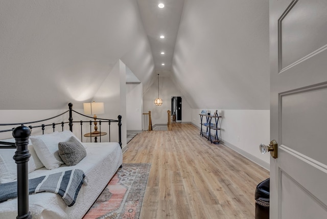 bedroom with lofted ceiling, baseboards, light wood finished floors, and recessed lighting