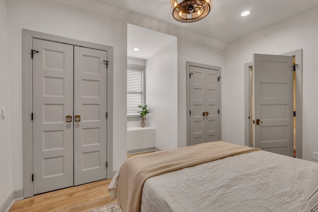 bedroom with baseboards, light wood-type flooring, and recessed lighting