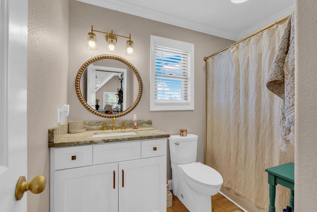 full bath featuring ornamental molding, vanity, and toilet