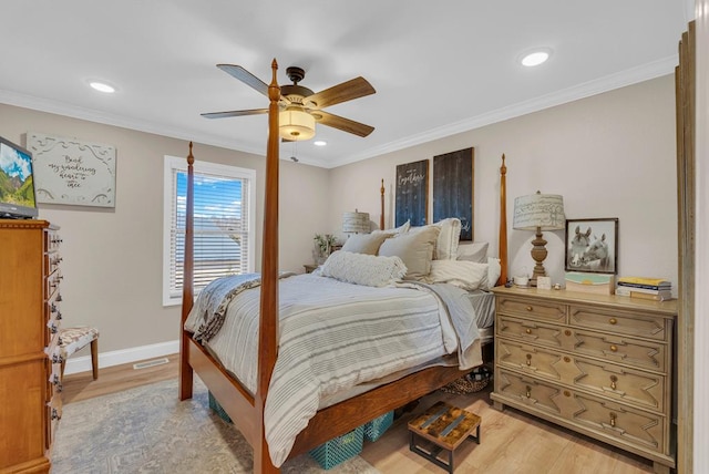 bedroom with crown molding and light wood finished floors