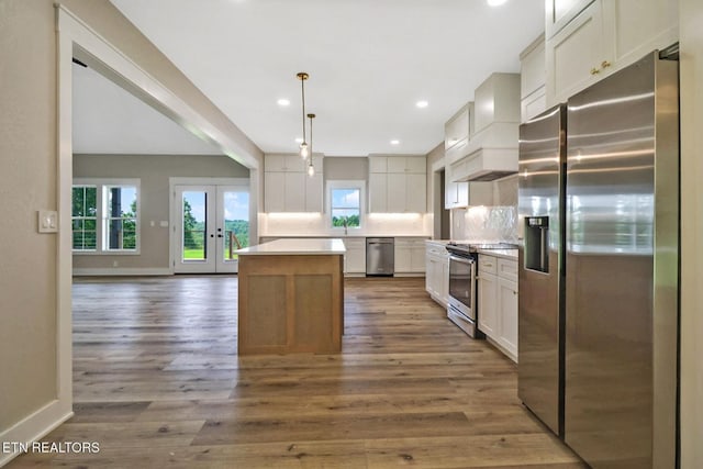 320 Ridge Ln, Monterey, TN 38574 - kitchen featuring stainless steel appliances, premium range hood, french doors, a kitchen island, and light countertops