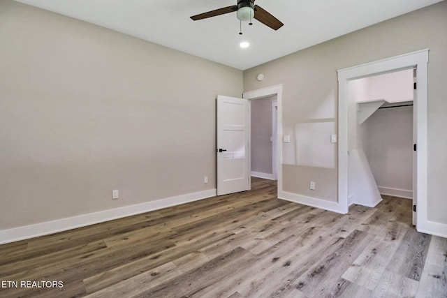 320 Ridge Ln, Monterey, TN 38574 - unfurnished bedroom featuring wood finished floors, a spacious closet, a ceiling fan, and recessed lighting