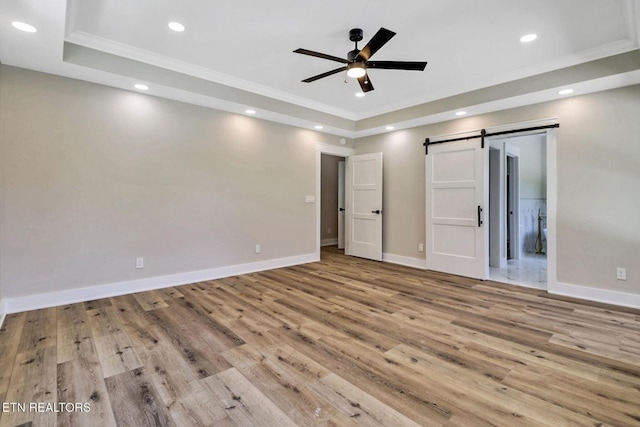320 Ridge Ln, Monterey, TN 38574 - unfurnished bedroom with a tray ceiling, crown molding, a barn door, wood finished floors, and recessed lighting