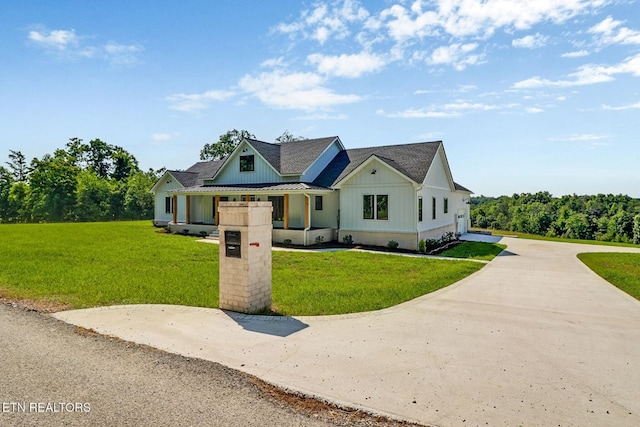 320 Ridge Ln, Monterey, TN 38574 - modern inspired farmhouse with board and batten siding, concrete driveway, a front yard, a metal roof, and a standing seam roof