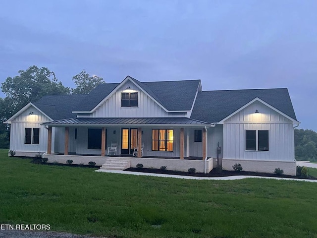 320 Ridge Ln, Monterey, TN 38574 - modern inspired farmhouse featuring board and batten siding, a standing seam roof, a front yard, and a porch