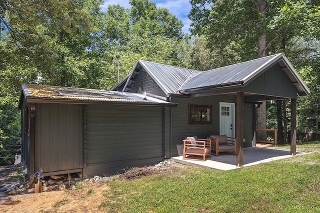 122 Abby Ln, Byrdstown, TN 38549 - exterior space featuring a yard, a metal roof, and a patio area