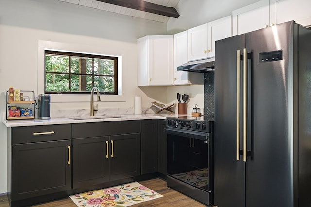 122 Abby Ln, Byrdstown, TN 38549 - kitchen featuring freestanding refrigerator, black electric range, white cabinetry, under cabinet range hood, and dark wood-style floors