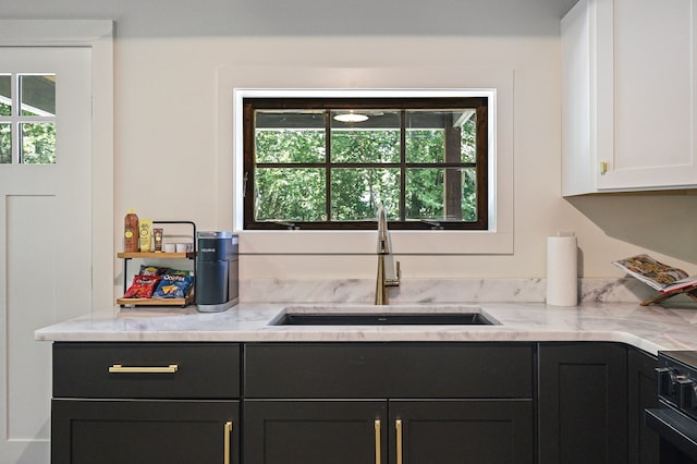 122 Abby Ln, Byrdstown, TN 38549 - kitchen with plenty of natural light, white cabinets, light stone counters, and range