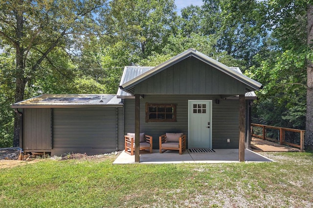 122 Abby Ln, Byrdstown, TN 38549 - rear view of property with a patio, a yard, and a metal roof