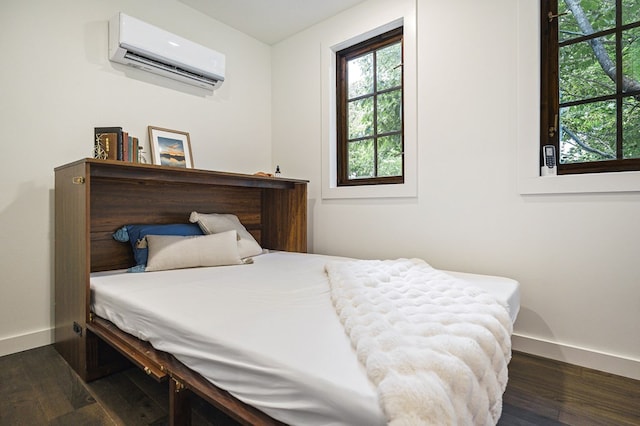122 Abby Ln, Byrdstown, TN 38549 - bedroom with a wall mounted AC and dark wood-type flooring
