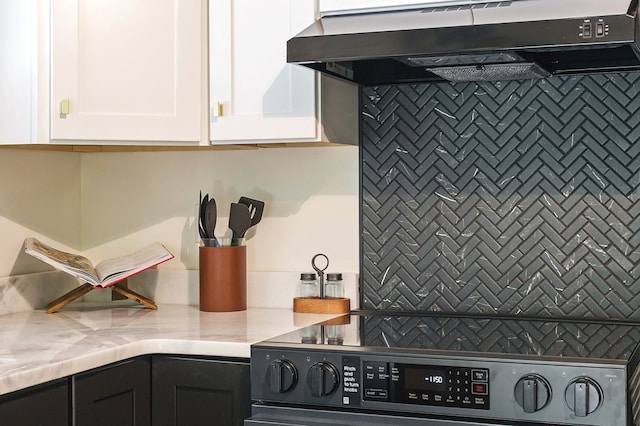 122 Abby Ln, Byrdstown, TN 38549 - kitchen with under cabinet range hood, range, white cabinets, and light countertops