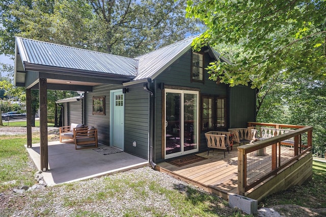 122 Abby Ln, Byrdstown, TN 38549 - back of house with a wooden deck and a metal roof