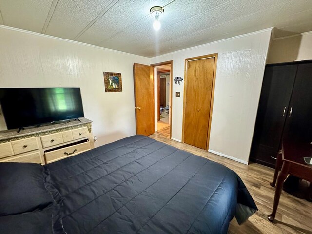 151 Dykes Ln, Crossville, TN 38571 - bedroom with dark wood-style flooring and ornamental molding