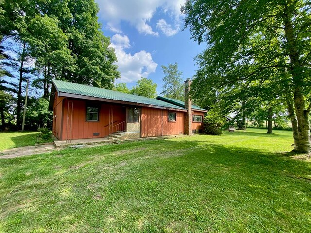 151 Dykes Ln, Crossville, TN 38571 - view of front of home featuring a front lawn, board and batten siding, and metal roof