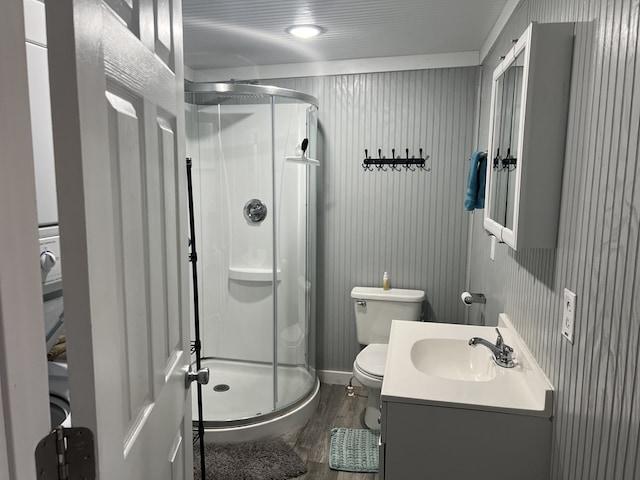 full bathroom with vanity, toilet, wood finished floors, and a shower stall