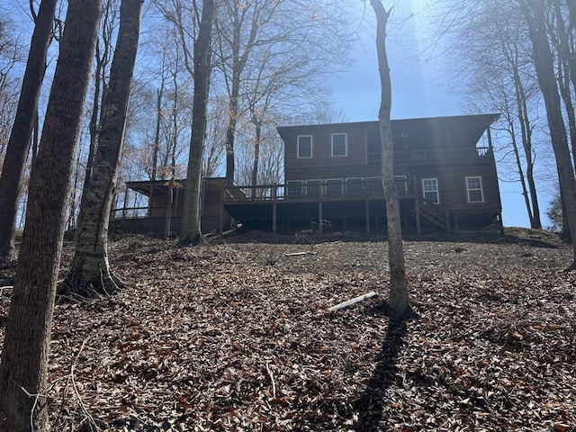 back of house featuring stairway and a deck