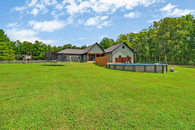2810 Stockton Rd, Jamestown, TN 38556 - rear view of house with a trampoline, an outdoor pool, and a fenced backyard