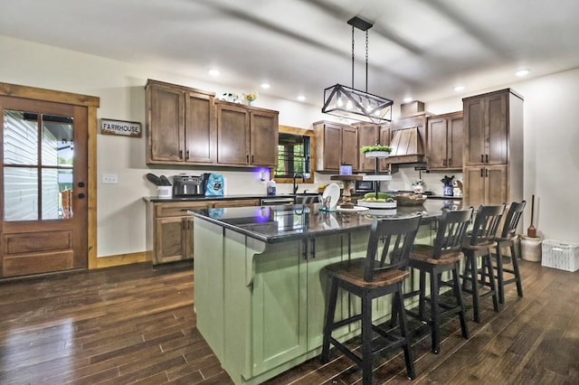 2810 Stockton Rd, Jamestown, TN 38556 - kitchen featuring dark countertops, dark wood-style flooring, a center island, a kitchen breakfast bar, and recessed lighting