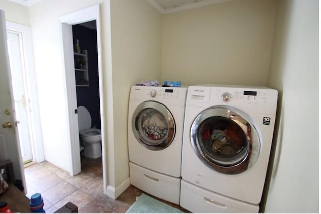 washroom featuring washer and dryer and light tile patterned floors