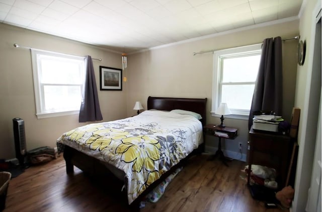 bedroom featuring dark wood finished floors and crown molding