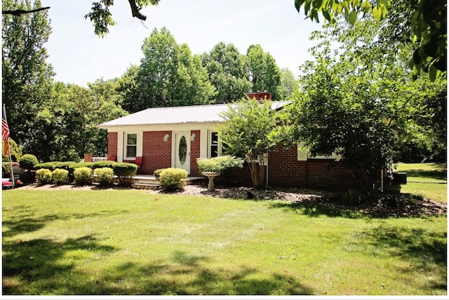 ranch-style house featuring brick siding and a front lawn