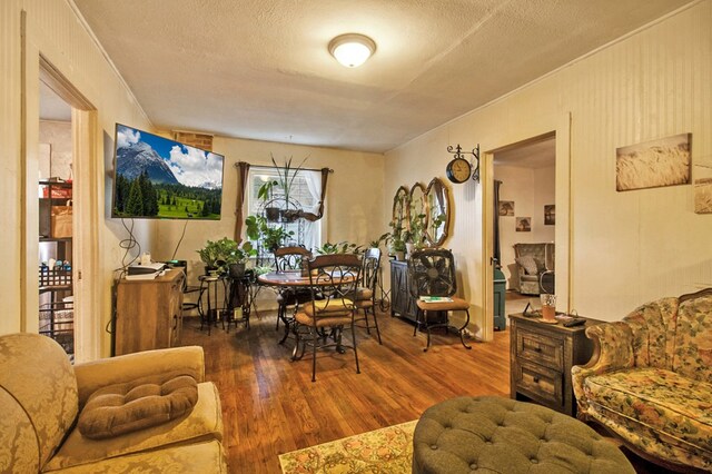 interior space with dark wood-style floors, ornamental molding, and a textured ceiling