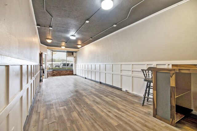 empty room with a wainscoted wall and wood finished floors