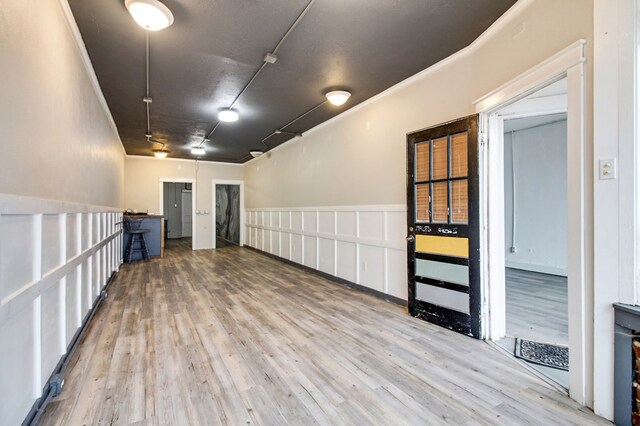 unfurnished room featuring ornamental molding and wood finished floors