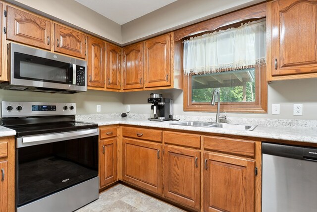 2876 Hilham Hwy, Hilham, TN 38568 - kitchen featuring appliances with stainless steel finishes, brown cabinets, and light countertops
