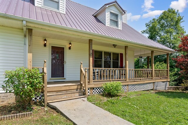 2876 Hilham Hwy, Hilham, TN 38568 - view of exterior entry featuring covered porch, a metal roof, and a yard