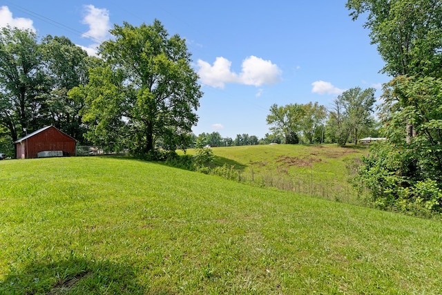 2876 Hilham Hwy, Hilham, TN 38568 - view of grassy yard featuring a detached garage and an outbuilding