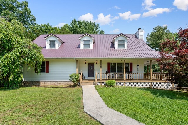 2876 Hilham Hwy, Hilham, TN 38568 - cape cod home featuring covered porch, a front yard, a chimney, and a metal roof