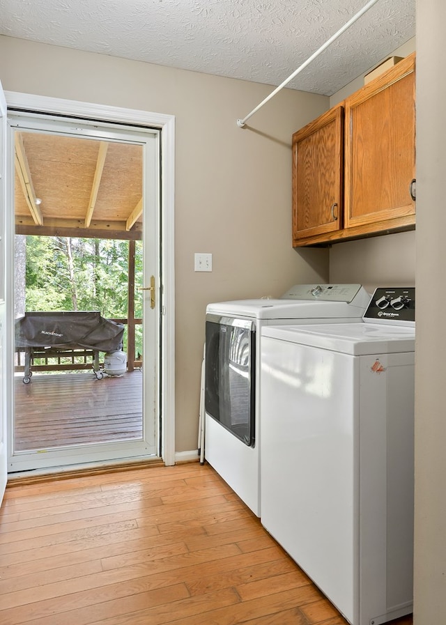 2876 Hilham Hwy, Hilham, TN 38568 - laundry area with washing machine and dryer, cabinet space, and light wood-type flooring