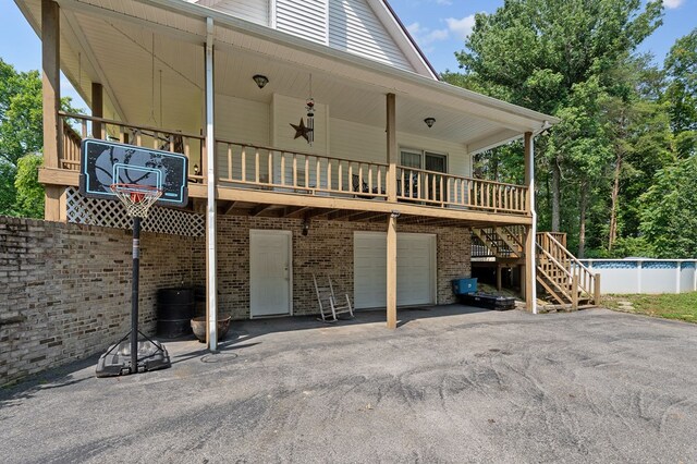 2876 Hilham Hwy, Hilham, TN 38568 - rear view of house featuring asphalt driveway, stairs, an attached garage, an outdoor pool, and brick siding