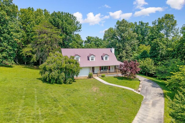 2876 Hilham Hwy, Hilham, TN 38568 - cape cod house with a porch, a front lawn, a chimney, and a metal roof