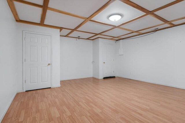 unfurnished room featuring light wood-type flooring, baseboards, and coffered ceiling