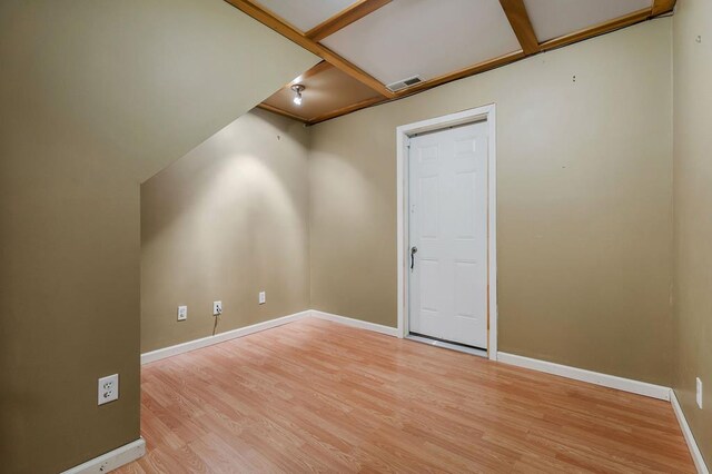 additional living space featuring light wood-style floors, baseboards, and visible vents