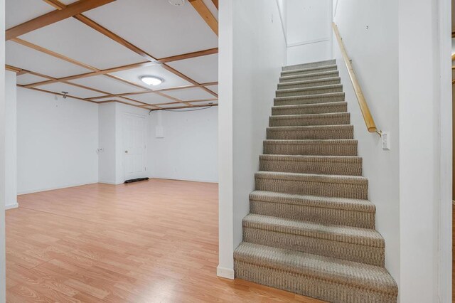 stairs featuring wood finished floors