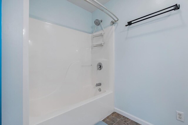 full bathroom with shower / tub combination, baseboards, and tile patterned floors