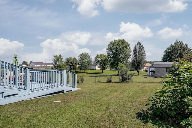 view of yard featuring a wooden deck and fence