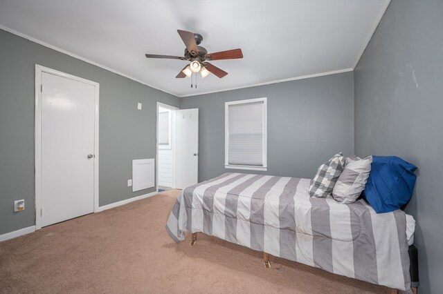 bedroom with carpet, baseboards, ceiling fan, and crown molding