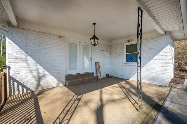 property entrance featuring brick siding