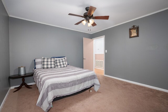 bedroom with baseboards, ornamental molding, a ceiling fan, and light colored carpet