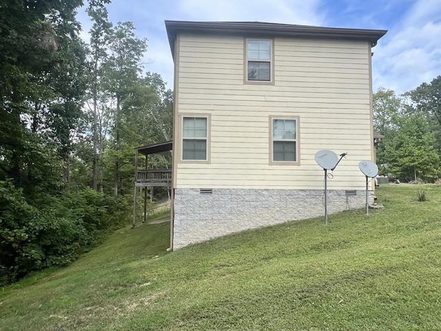 view of home's exterior featuring crawl space and a lawn