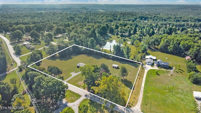 aerial view with a water view and a wooded view