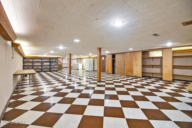 finished basement with dark floors and visible vents