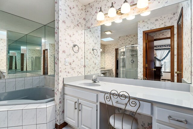 bathroom with a stall shower, vanity, a bath, and wallpapered walls