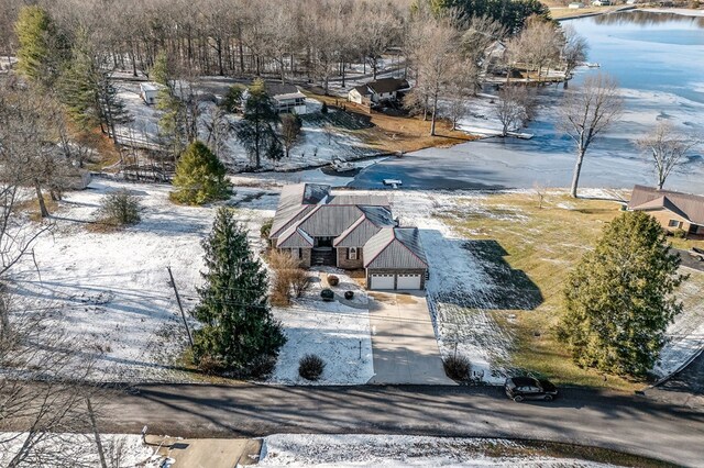 snowy aerial view featuring a water view