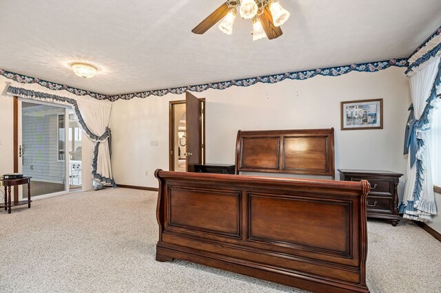 carpeted bedroom featuring access to outside, ceiling fan, a textured ceiling, and baseboards